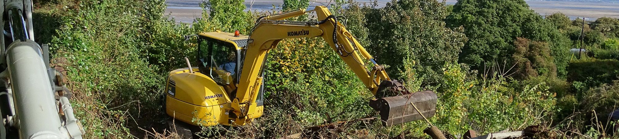 Site clearance using digger in North Wales